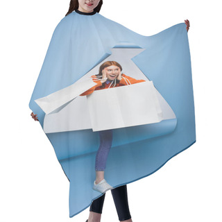 Personality  Young Amazed Woman Holding Shopping Bags On Blue Ripped Paper Background  Hair Cutting Cape