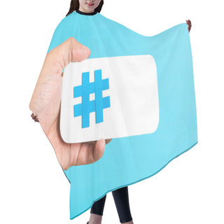 Personality  Hand Showing A Hashtag Symbol / Sign On White Paper With Phone Mobile Shape, With Blue Background. Internet, Social Media Concept Hair Cutting Cape