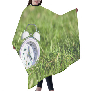 Personality  White Color Alarm Clock On Green Grass. Place For Text. Time, Circadian Rhythm, Early Rise Concept. Hair Cutting Cape