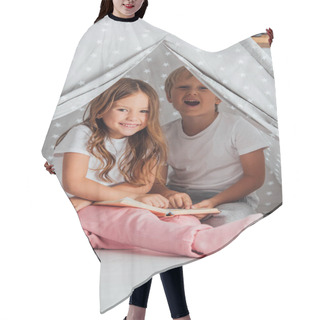 Personality  Excited Brother And Sister In Pajamas Looking At Camera While Sitting In Kids Wigwam And Reading Book Hair Cutting Cape