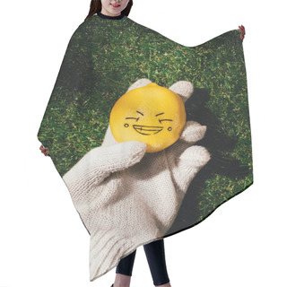 Personality  Cropped Shot Of Person Holding Lemon With Drawing Face On Green Lawn  Hair Cutting Cape