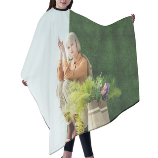 Personality  Beautiful Fashionable Girl Posing Near Bag With Fern And Flowers On White With Green Grass  Hair Cutting Cape