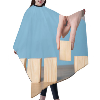 Personality  Woman Arranging Empty Cubes In Row On Wooden Table Against Light Blue Background, Closeup. Space For Text Hair Cutting Cape
