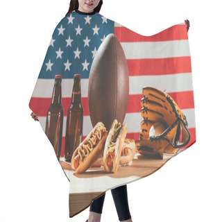 Personality  Close-up View Of Hot Dogs, Beer Bottles, Rugby Ball And Baseball Glove With Ball On Wooden Table With Us Flag Behind  Hair Cutting Cape