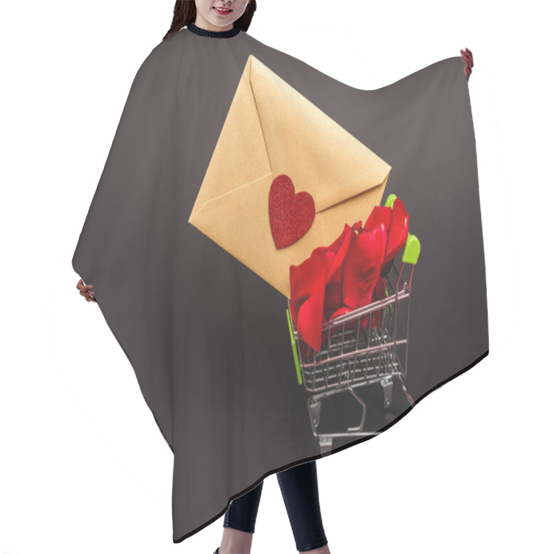 Personality  shopping cart with rose petals and envelope isolated on black hair cutting cape