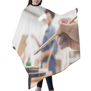 Personality  Cropped View Of Man Holding Shaper In Hand Near Flat Clay Piece And Blurred African American Woman Hair Cutting Cape
