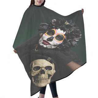 Personality  Woman In Black Wreath And Day Of Death Costume Looking At Camera Near Skull On Dark Green Background  Hair Cutting Cape