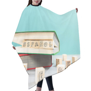 Personality  On The Table Are Books And Wooden Cubes With An Inscription In Spanish. Turquoise Background. Copy Space. The Concept Of Learning Foreign Languages. Hair Cutting Cape