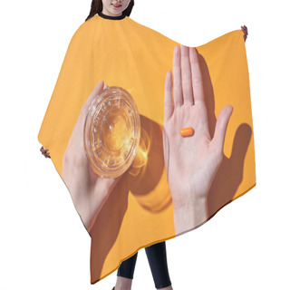 Personality  Cropped View Of Woman Holding Pill On Palm Near Glass With Water On Orange Background Hair Cutting Cape