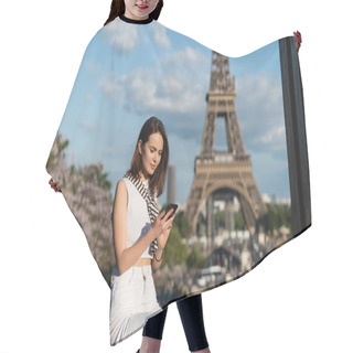 Personality  Young Woman In Stylish Outfit Using Smartphone While Sitting Near Eiffel Tower In Paris  Hair Cutting Cape