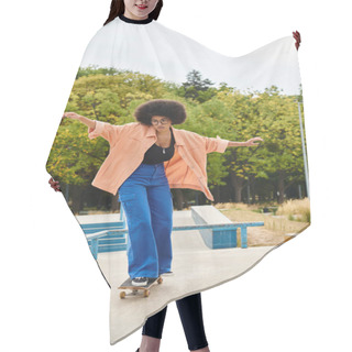 Personality  A Young African American Woman With Curly Hair Effortlessly Rides A Skateboard On Top Of A Cement Slab In An Urban Skate Park. Hair Cutting Cape