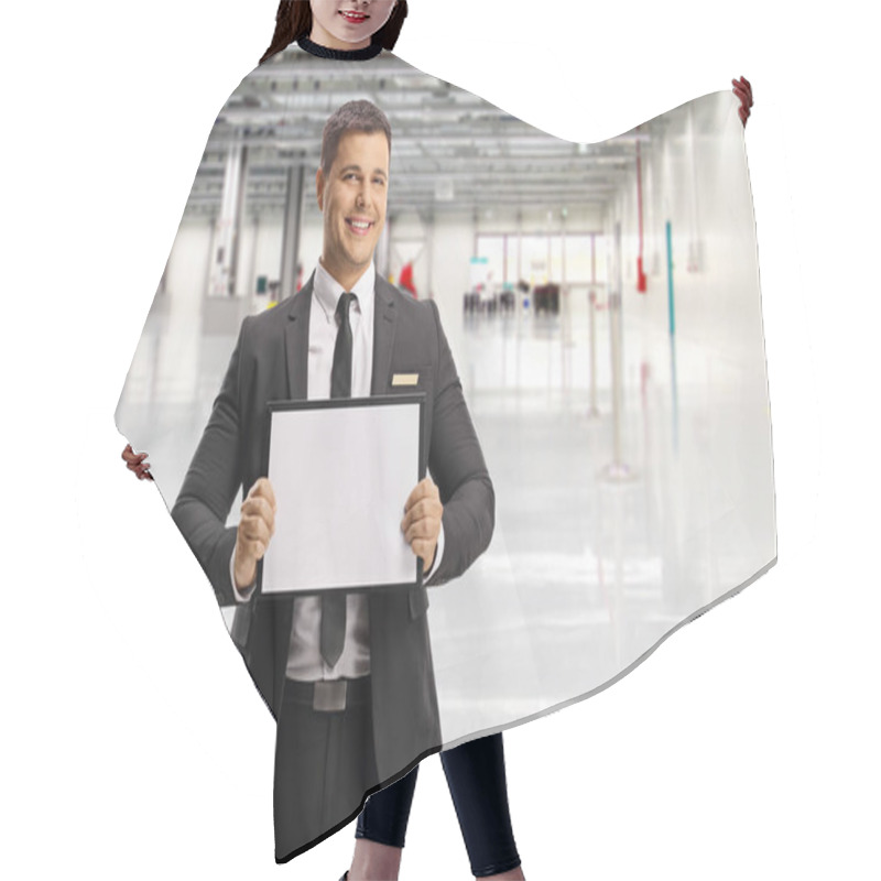 Personality  Man waiting a passenger at an airport with a name board  hair cutting cape