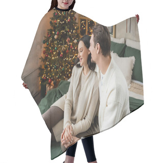 Personality  Cheerful Married Couple Sitting On Bed Together Near Decorated Christmas Tree In Modern Apartment Hair Cutting Cape