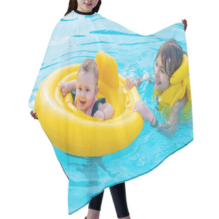 Personality  Baby Swims In A Circle On The Sea. Selective Focus. Child. Hair Cutting Cape