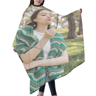 Personality  Young Woman With Knitted Sweater On Shoulders Blowing On Daisy In Summer Park  Hair Cutting Cape