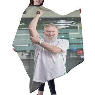 Personality  Happy And Bearded Elderly Man Smiling And Looking At Camera, Working Out With Dumbbell In Gym Hair Cutting Cape