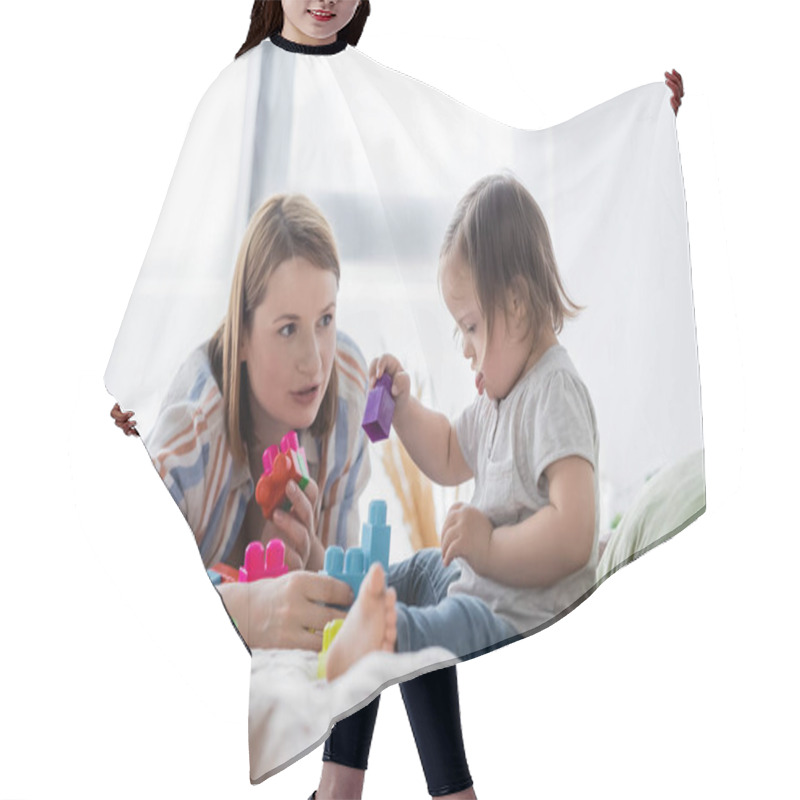 Personality  Child With Down Syndrome Playing Building Blocks Near Mom In Bedroom  Hair Cutting Cape