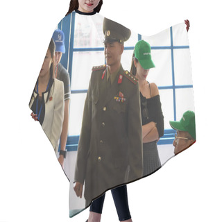 Personality  Panmunjom, North Korea - May 5, 2019:Guide In Uniform Gives Tourists Explanation Abou The North Korea Peace Museum In Joint Security Area. The Demilitarized Zone Hair Cutting Cape