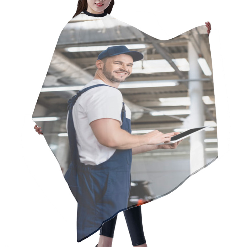 Personality  Cheerful Mechanic In Uniform And Cap Holding Digital Tablet With Blank Screen In Workshop  Hair Cutting Cape