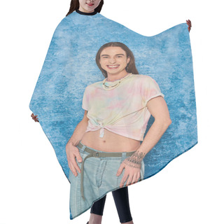 Personality  Cheerful Young Gay Man With Tattoo And Long Hair Standing In Denim Jeans And Tied Knot On T-shirt Showing His Belly During Pride Month On Mottled Blue Background  Hair Cutting Cape