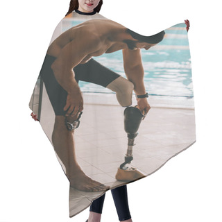 Personality  Handsome Swimmer Standing At Poolside Of Indoor Swimming Pool And Taking Off Artificial Leg Hair Cutting Cape