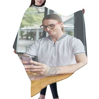Personality  Close Up Cheerful Young Man In Glasses Looking At Phone With Glass Background, Coworking Concept Hair Cutting Cape