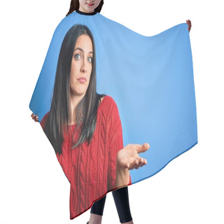 Personality  Young Brunette Woman With Blue Eyes Wearing Red Casual Sweater Over Isolated Background Clueless And Confused Expression With Arms And Hands Raised. Doubt Concept. Hair Cutting Cape