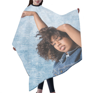 Personality  Curly African American Woman In Denim Vest Looking At Camera While Posing On Blue Background Hair Cutting Cape
