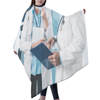 Personality  Partial View Of Male Doctor Pointing At Clipboard To Female Doctor With Digital Tablet In Hospital Corridor  Hair Cutting Cape