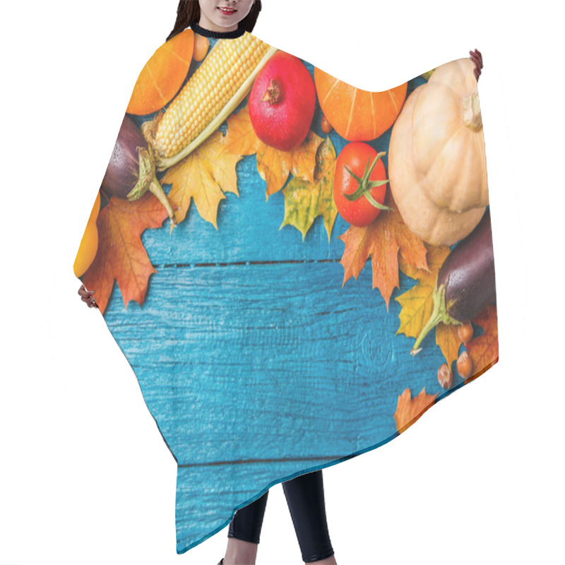 Personality  Image of blue wooden table with autumn vegetables, with place for inscription hair cutting cape