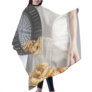 Personality  A Woman Is Dumping Fresh Made Potato Waffle Fries From Basket Onto A Countertop Together With Chicken Nuggets. She Fried Them In Air Fryer Using Very Little Fat. A Healthy Homemade Convenient Snack. Hair Cutting Cape