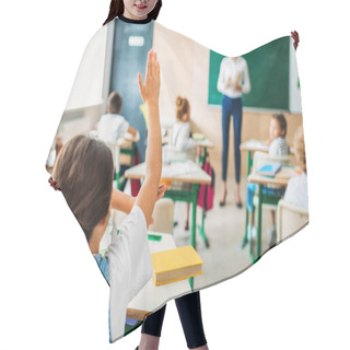 Personality  Rear View Of Schoolgirl Raising Hand To Answer Teachers Question During Lesson Hair Cutting Cape