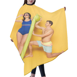 Personality  Attractive Woman In Blue Swimsuit Touching Glasses And Shirtless Man Standing On Knee Near Inflatable Mattress On Yellow Background Hair Cutting Cape
