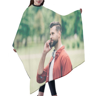 Personality  Young Man Standing In Park And Talking On Smartphone  Hair Cutting Cape
