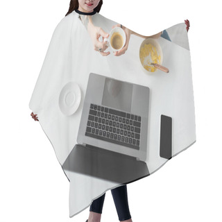 Personality  Top View Of Woman With Tattoo On Hand Holding Cup Of Coffee Near Bowl With Cornflakes During Breakfast While Using Laptop Near Smartphone With Blank Screen In Modern Kitchen, Freelancer, Cropped  Hair Cutting Cape