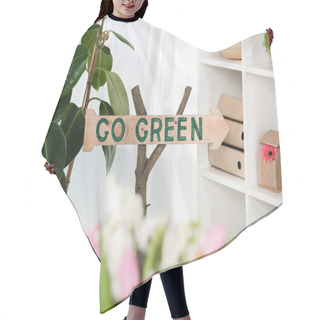 Personality  Selective Focus Of Wooden Sign With Go Green Lettering Near Plants In Office, Environmental Saving Concept  Hair Cutting Cape