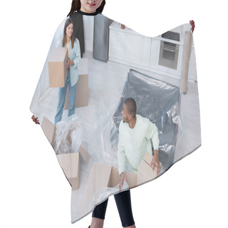 Personality  High Angle View Of Pleased Interracial Couple Unpacking Boxes During Relocation  Hair Cutting Cape