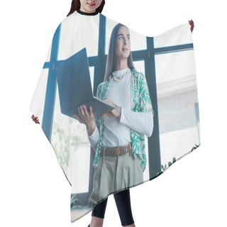 Personality  Low Angle View Of Nonbinary Person Holding Laptop In Creative Agency  Hair Cutting Cape