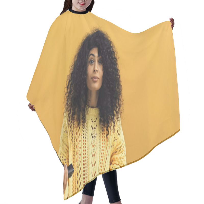Personality  Young Hispanic Woman Holding Remote Controller Isolated On Yellow Hair Cutting Cape