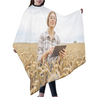 Personality  Young Woman In A Golden Wheat Field With Tablet Checks The Growth And Quality Of The Crop. Agriculture, Gardening, Business Or Ecology Concept. Hair Cutting Cape