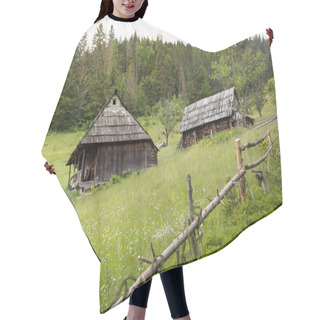 Personality  Two Old Wooden House On A Hillside, Surrounded By A Fence. Forest And Mountains In The Background. Nature Conceptual Image. Hair Cutting Cape