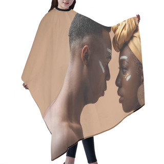 Personality  Side View Of Naked Tribal Afro Couple Posing Face To Face On Beige Hair Cutting Cape