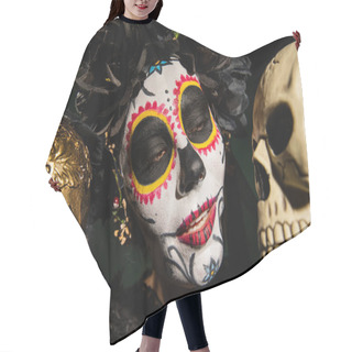 Personality  Portrait Of Woman In Mexican Santa Muerte Makeup Looking At Skull Isolated On Black  Hair Cutting Cape