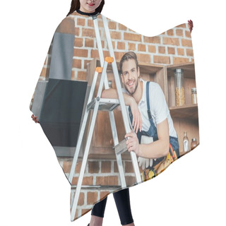 Personality  Handsome Young Foreman Standing On Ladder And Smiling At Camera While Fixing Kitchen Hood  Hair Cutting Cape
