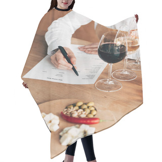 Personality  Cropped View Of Sommelier In Apron Sitting At Table And Writing In Wine Tasting Document Hair Cutting Cape