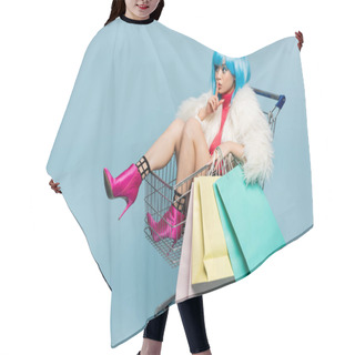 Personality  Asian Woman In Bright Wig And Furry Jacket Holding Shopping Bags In Cart And Showing Secret Gesture On Blue Background  Hair Cutting Cape