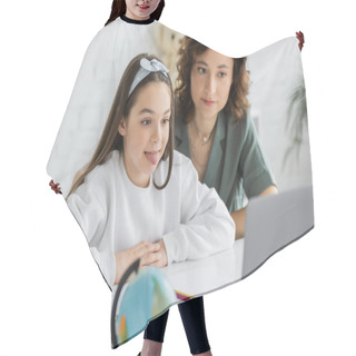 Personality  Preteen Girl Sticking Out Tongue During Speech Therapy Online Lesson Near Mom At Home  Hair Cutting Cape