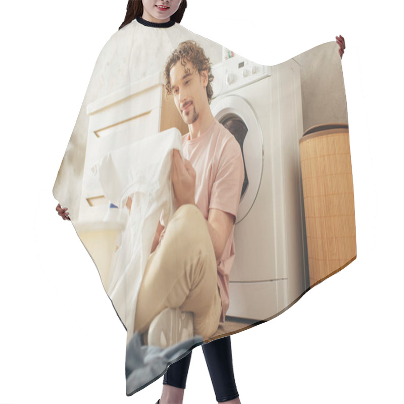 Personality  A Man In Cozy Homewear Sits Beside A Washing Machine In A Cleaning Spree. Hair Cutting Cape