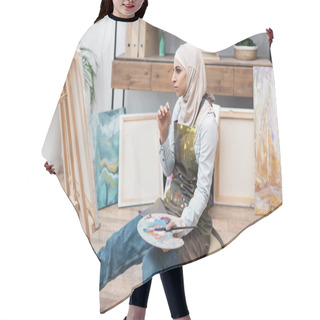 Personality  Muslim Woman With Palette Sitting Near Easel In Home Studio Hair Cutting Cape