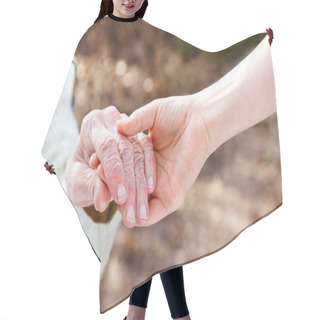 Personality  Senior Lady Holding Hands With Young Caretaker Hair Cutting Cape